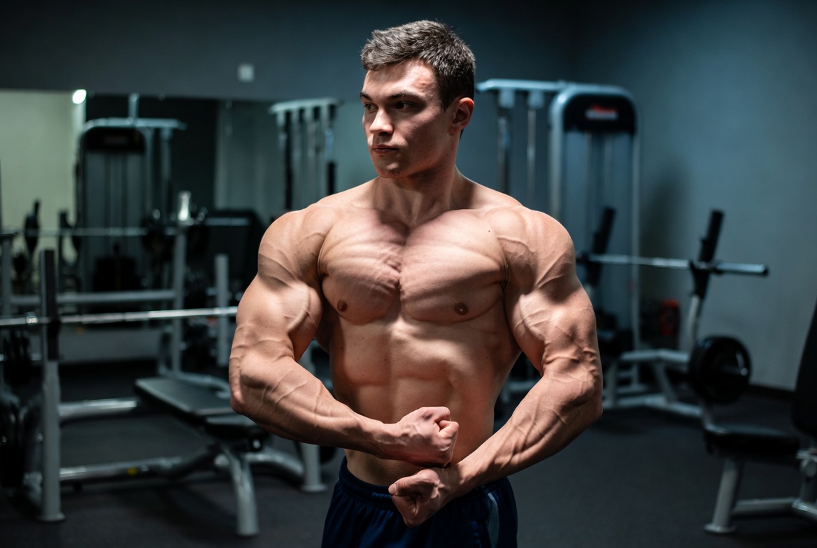 A high-definition photo of a bodybuilder with extreme vascularity and lean muscle density, illustrating the results of a steady muscle growth cycle when you Buy Pharma BOLD 300 Ampoules.