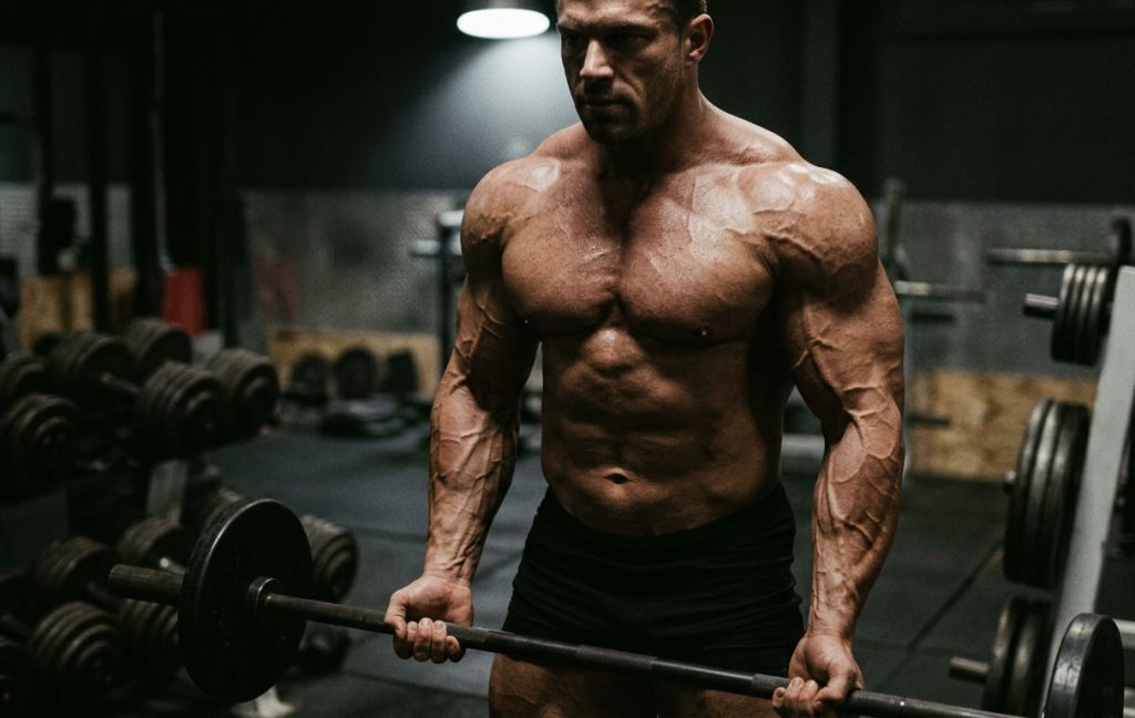 A highly conditioned bodybuilder showcasing the extreme muscle hardness and dense vascularity associated with a successful Ultima-Drostan P 100 cycle.